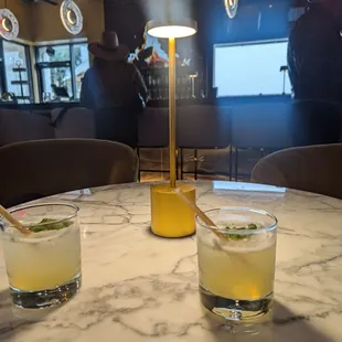 two cocktails on a marble table