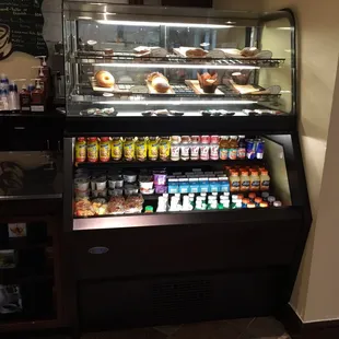 a display case with donuts and drinks