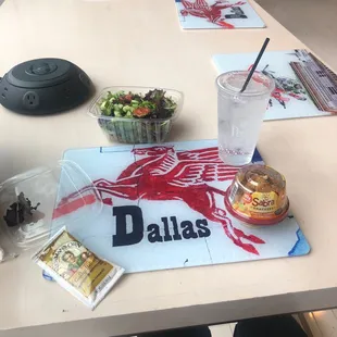 a table with a salad and drink