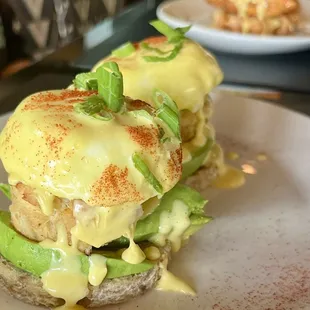 Crab Benedict and Nashville hot chicken Benedict in the the background