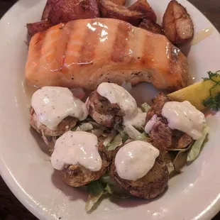 Grilled salmon, stuffed mushrooms and potatoes.