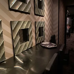 a row of mirrors on the wall