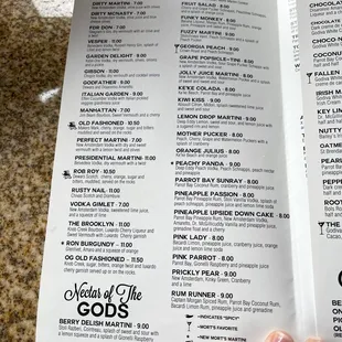 a hand holding a menu