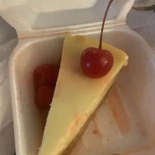 a slice of cheesecake with cherries