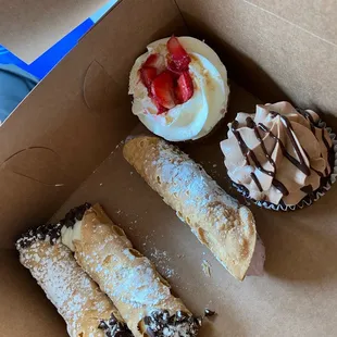 Original and blueberry cannolis  strawberry shortcake and chocolate cupcakes