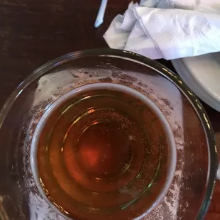 a glass of beer and a napkin