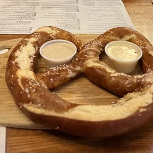 a pretzel with dipping sauces