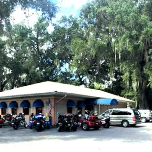 a group of motorcycles parked in a parking lot
