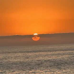 the sun setting over the ocean