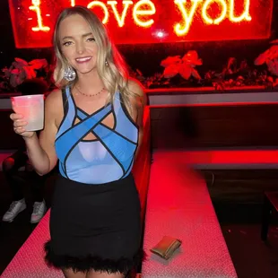a woman holding a drink