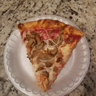 a slice of pizza on a paper plate
