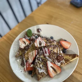 a plate of french toast and strawberries