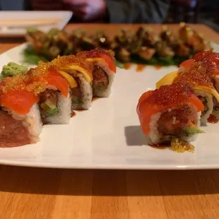 Geisha Roll (front) - spicy tuna and avocado; topped with salmon, mango, yuzu tobiko, unagi sauce