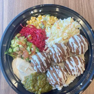 Falafel bowl with hummus, corn, cabbage, and rice.