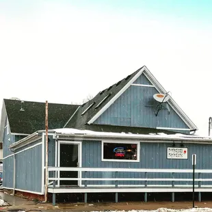 a blue building with a sign on it