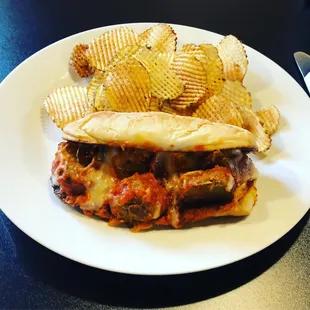 a sandwich and chips on a plate