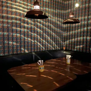 a wooden table and black leather booths