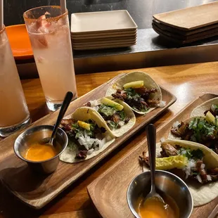 two plates of tacos and a drink