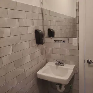 a bathroom with a sink and mirror