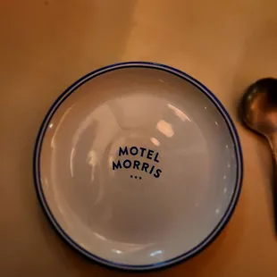 a plate with a spoon and spoon rest on a table