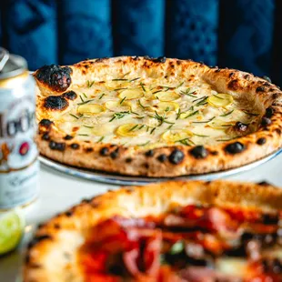 two pizzas and a can of beer