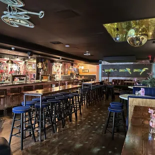 Interior photo of Motel No Tell showing the bar, tables and disco ball.