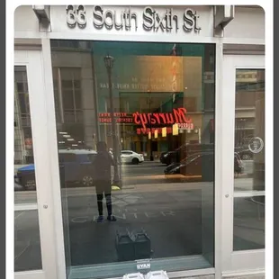 The photo sent to us by door dash on the ground in front of the closed building.