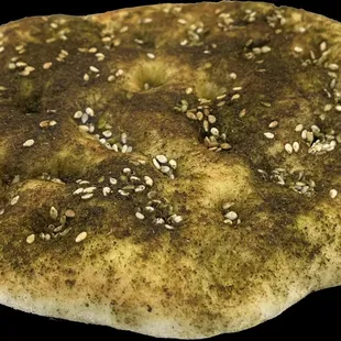 Pita Zaa'tar, freshly baked every day with olive oil and zaa'tar herb; goes with everything, or just by itself. Must Try.