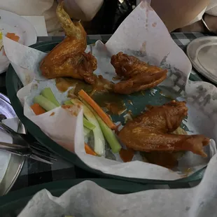 a tray of chicken wings and french fries