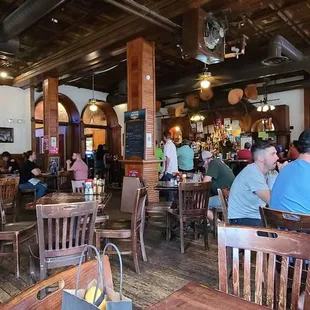 people sitting at tables in a restaurant