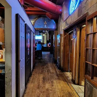 a long hallway with a neon sign