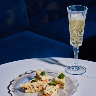a plate of food and a glass of wine