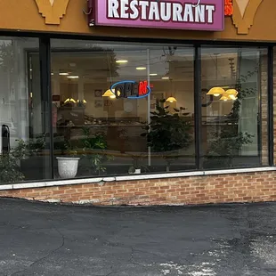 The bay window at the front entryway to the Restaurant as well as the parking lot.