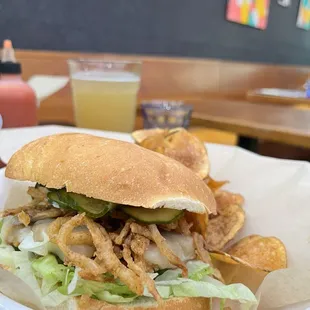 a plate of food with a sandwich and chips