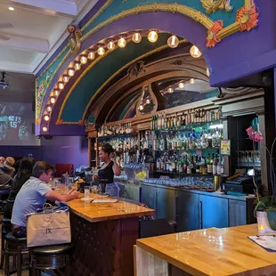 a bar with people sitting at the bar