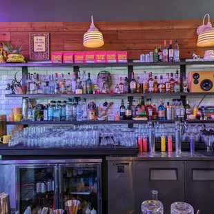 a bar with a variety of drinks