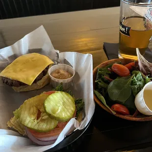 a sandwich, salad, and a glass of beer
