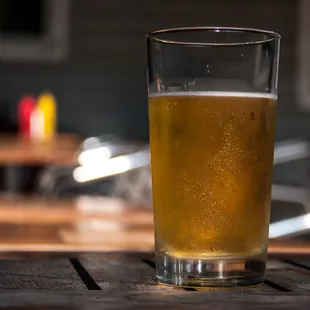 a glass of beer on a table