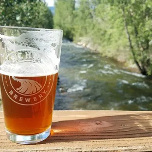 a pint of beer on a wooden table