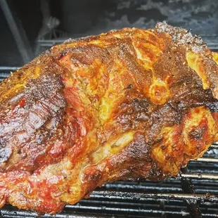 a large piece of meat on a grill