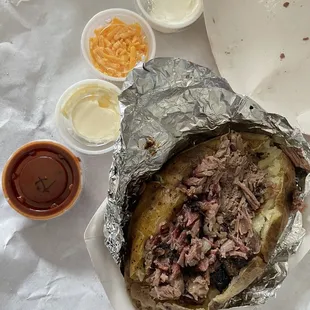 Baked potato with little meat and an oz of sauce