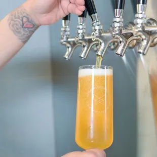 a person pouring a beer