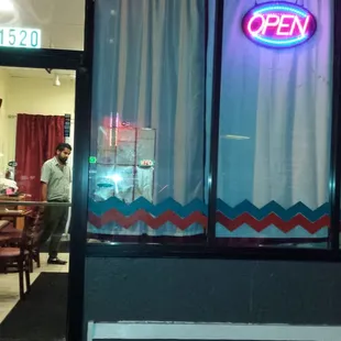 a man standing outside a restaurant