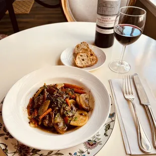a plate of food and a glass of wine