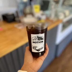 a hand holding a cup of coffee