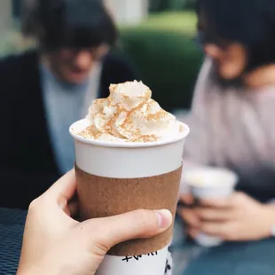 a person holding a cup of coffee