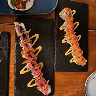 Tuna lover&apos;s roll (with black masago), and a salmon roll. Both are spicy rolls.