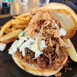 a pulled pork sandwich and french fries