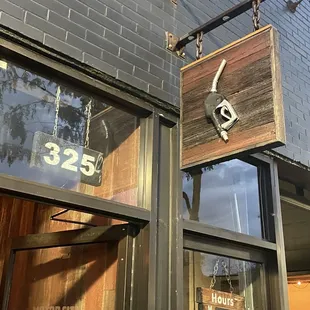 a sign hanging from the side of a building