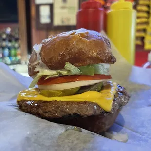 a hamburger with cheese and lettuce